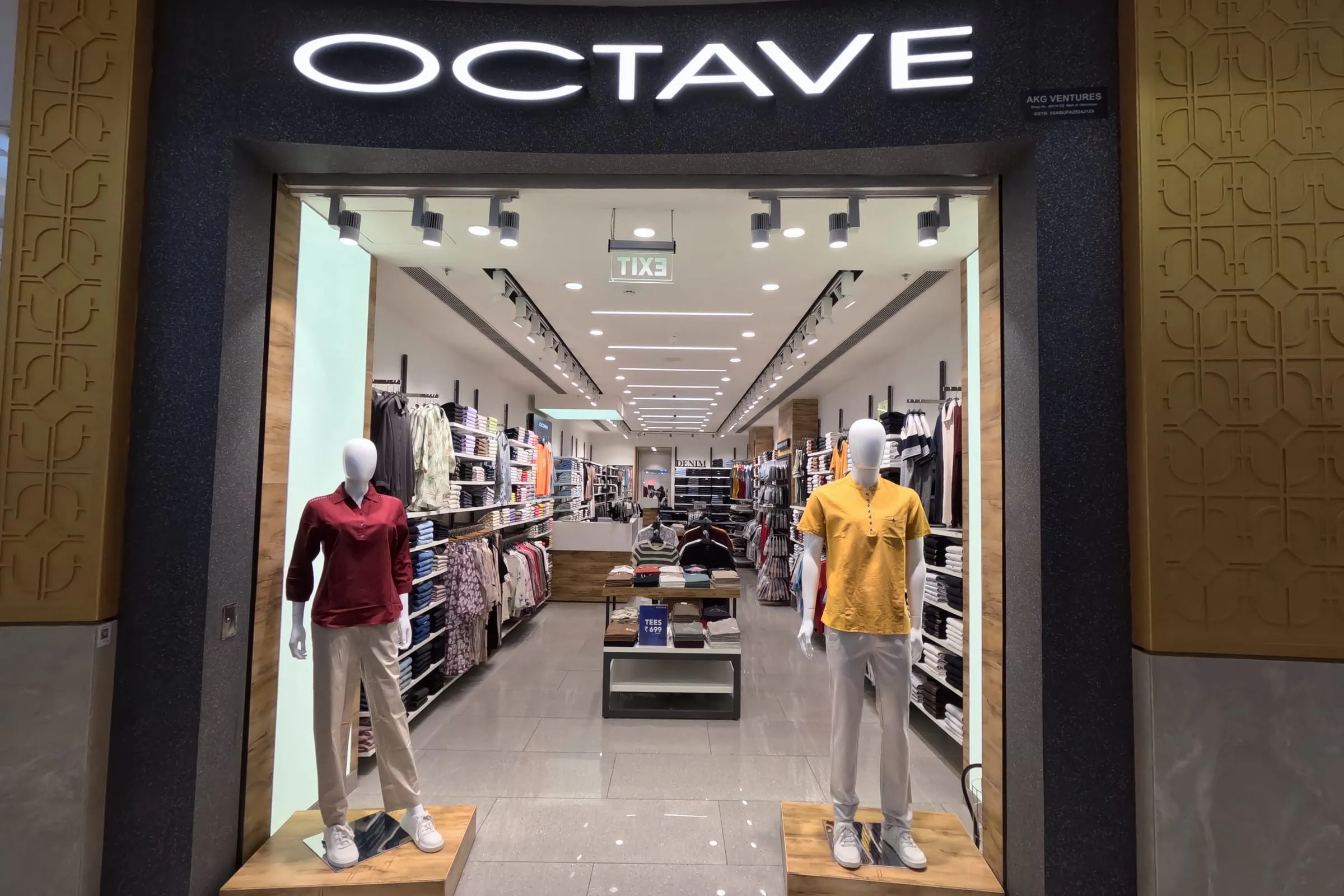 OCTAVE storefront: illuminated fascia above a glazed mall frontage, mannequins either side of the entrance.