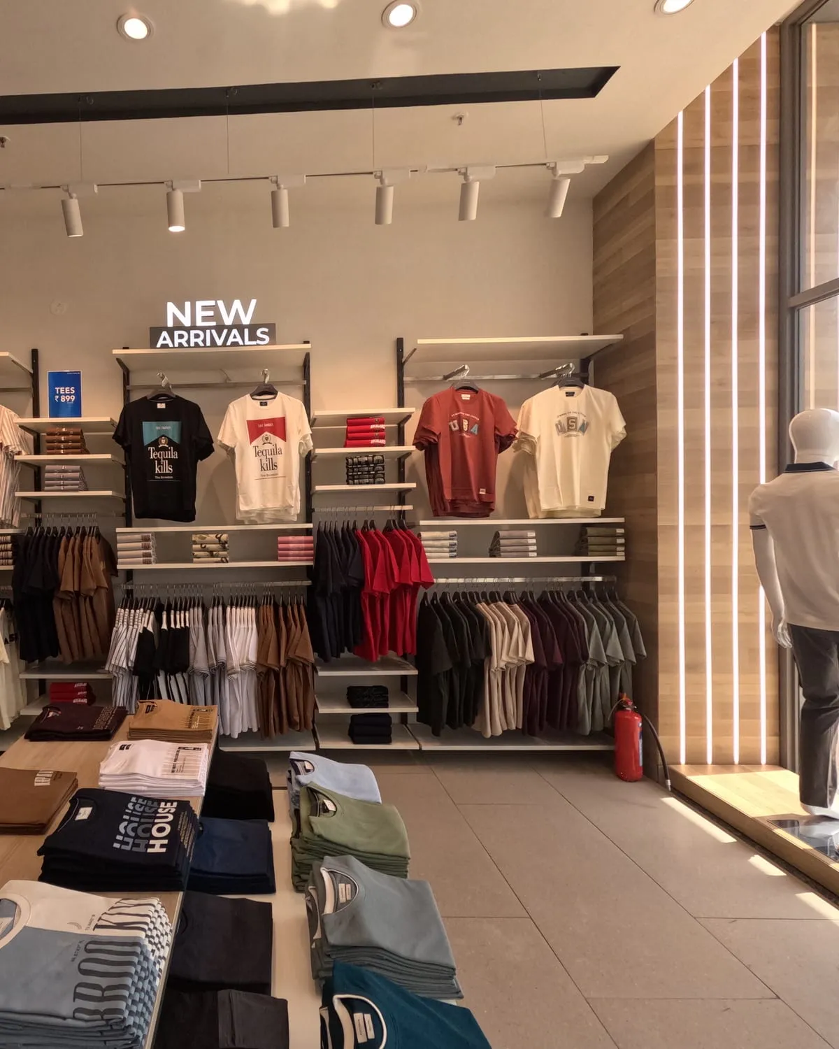 Interior looking toward the glazed shopfront, daylight across the sales floor.